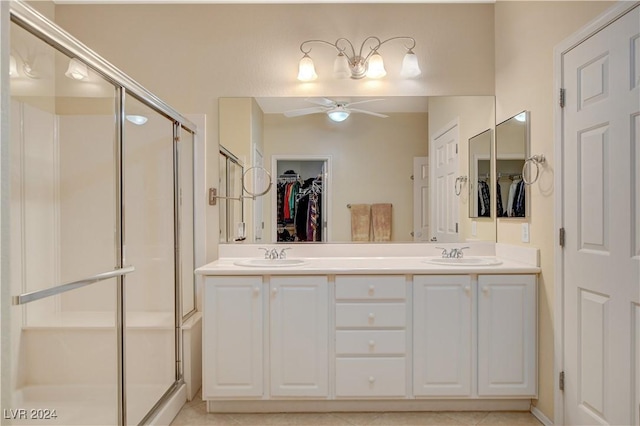 bathroom featuring tile patterned flooring, ceiling fan, walk in shower, and vanity