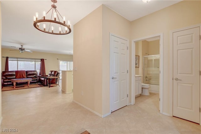 hall featuring light tile patterned floors and an inviting chandelier