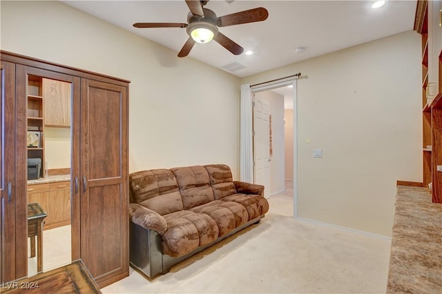 living room with ceiling fan and light colored carpet