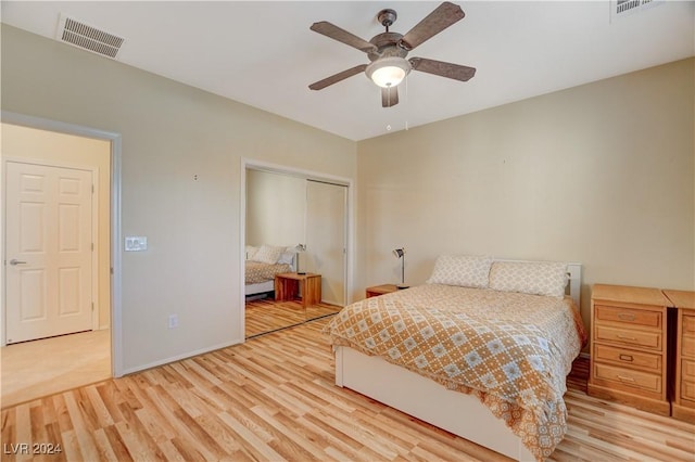 unfurnished bedroom with ceiling fan, light hardwood / wood-style flooring, and a closet