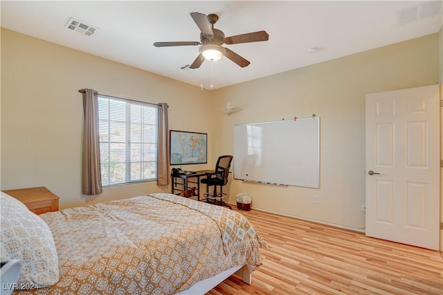 bedroom with ceiling fan and light hardwood / wood-style flooring