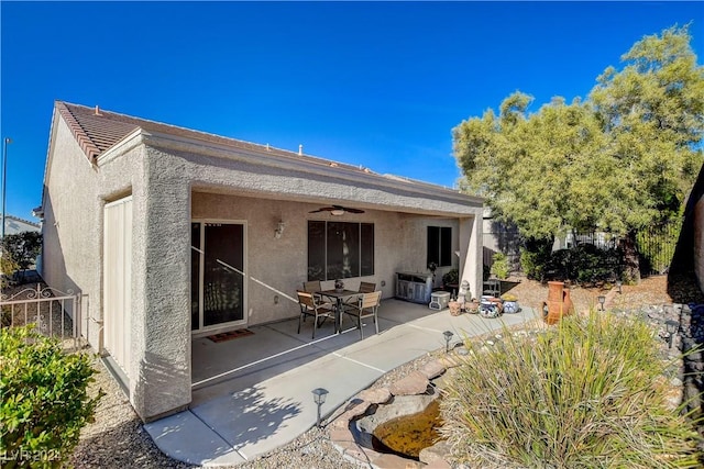 rear view of property with a patio area and ceiling fan