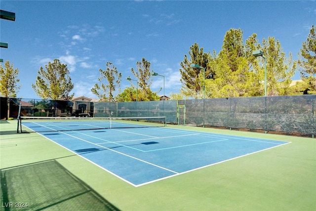 view of tennis court with basketball hoop