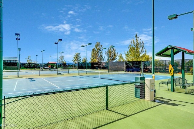 view of tennis court featuring basketball hoop