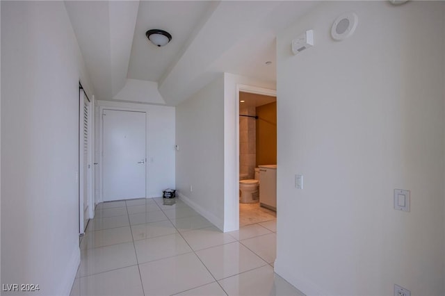 corridor featuring light tile patterned flooring