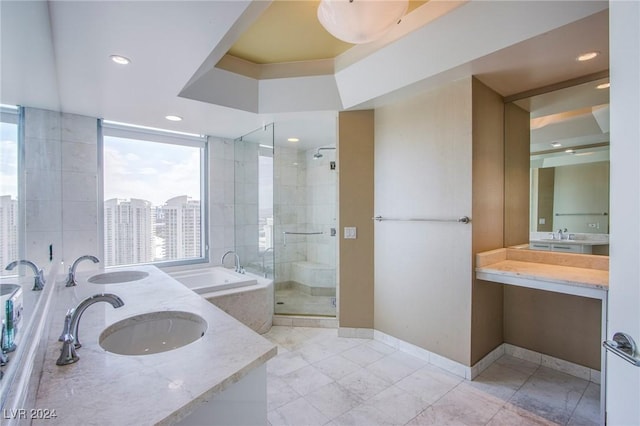 bathroom with vanity and independent shower and bath