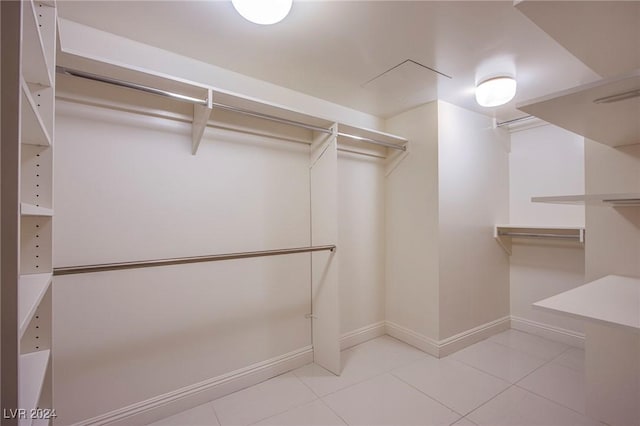 spacious closet featuring light tile patterned floors