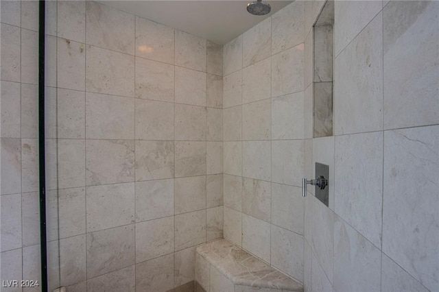 bathroom with tiled shower