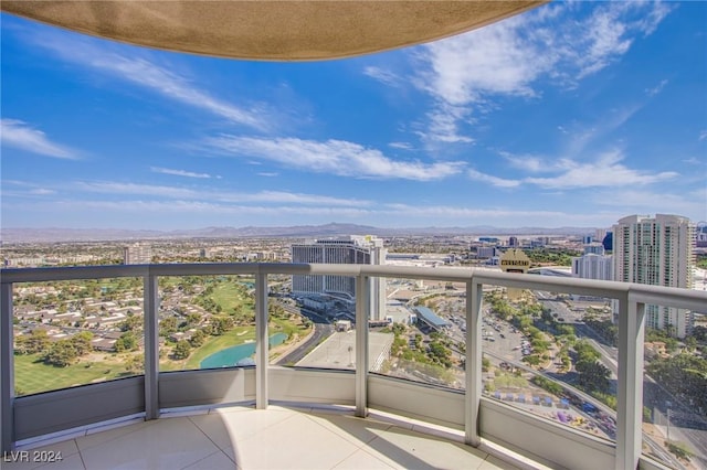 balcony featuring a city view and a mountain view