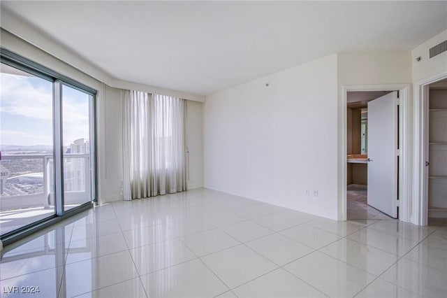 spare room featuring light tile patterned floors