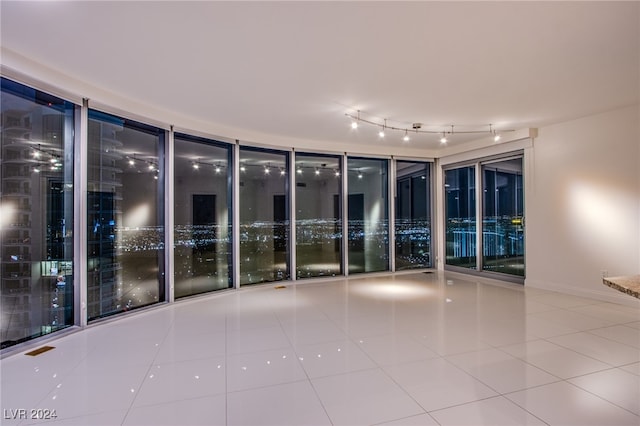empty room featuring tile patterned flooring and baseboards