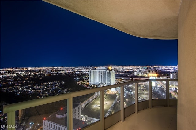 balcony at twilight featuring a view of city lights
