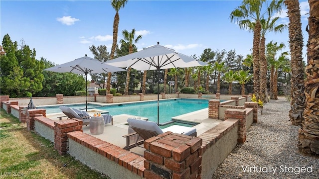 view of pool featuring an in ground hot tub and a patio