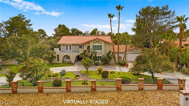 mediterranean / spanish house with a front yard, a balcony, and a garage