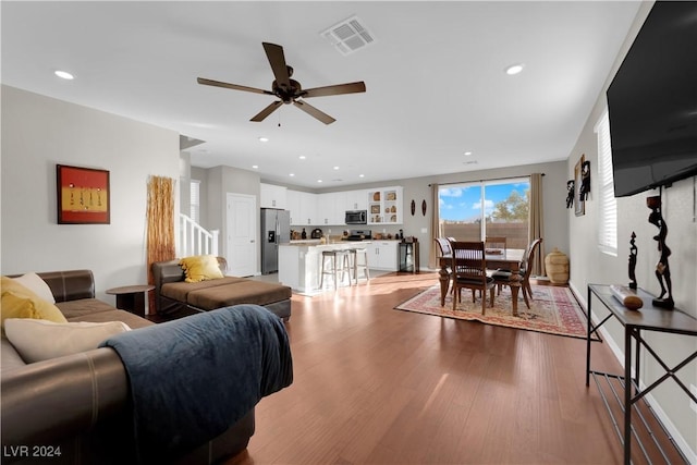 living room featuring ceiling fan and light wood-type flooring