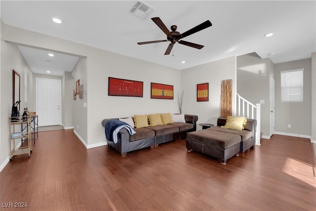 living room with ceiling fan and dark hardwood / wood-style flooring