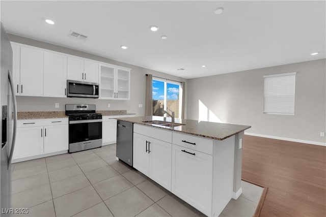 kitchen featuring stone counters, recessed lighting, a sink, visible vents, and appliances with stainless steel finishes