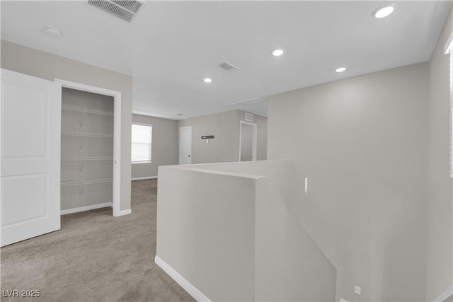 hall with carpet floors, recessed lighting, visible vents, an upstairs landing, and baseboards