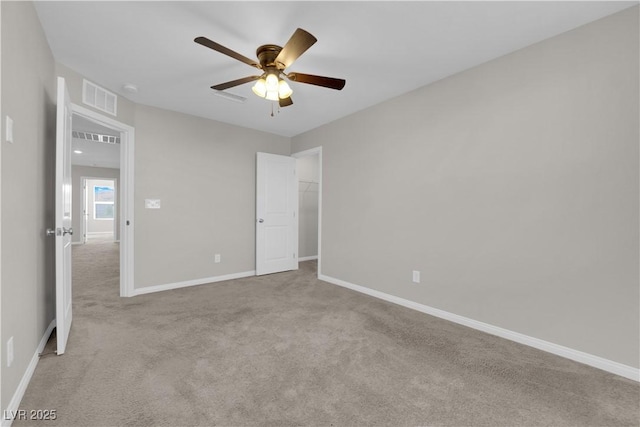 unfurnished bedroom featuring a ceiling fan, carpet, visible vents, and baseboards