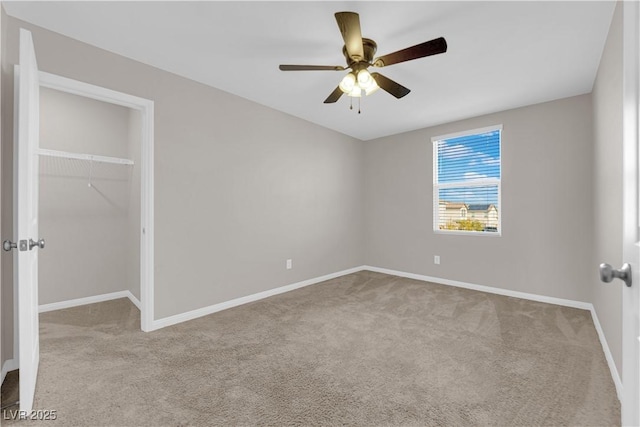 unfurnished bedroom with a closet, carpet flooring, a ceiling fan, and baseboards