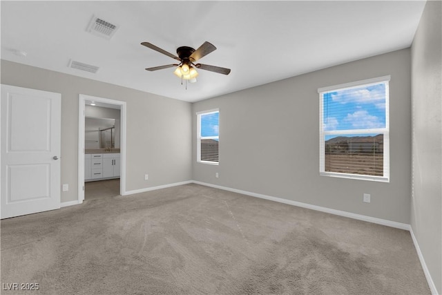 unfurnished bedroom with baseboards, visible vents, carpet flooring, and ensuite bathroom