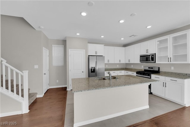 kitchen featuring appliances with stainless steel finishes, recessed lighting, white cabinetry, and a sink