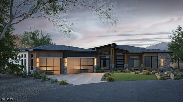 prairie-style house with a mountain view and a garage