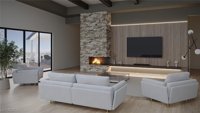 living area featuring a stone fireplace, beamed ceiling, and wood finished floors