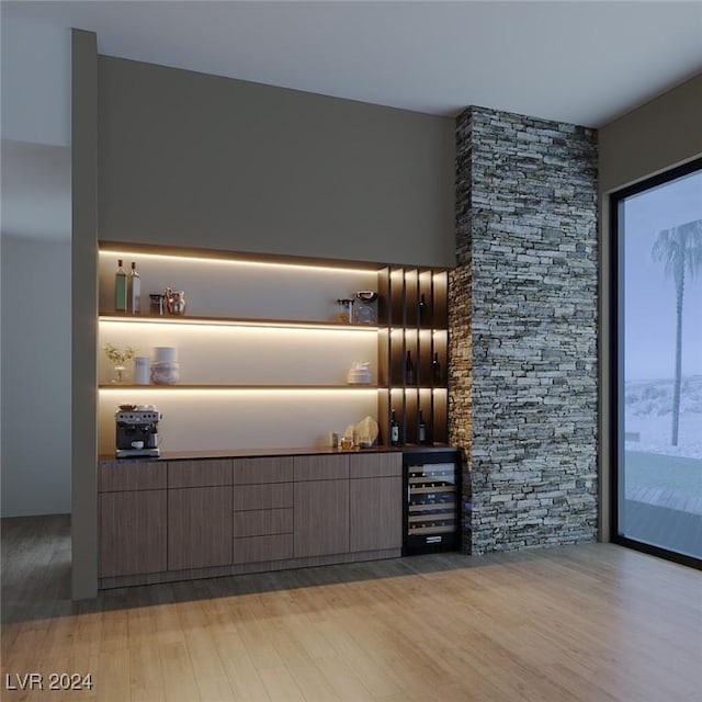 bar with light wood-type flooring and wine cooler