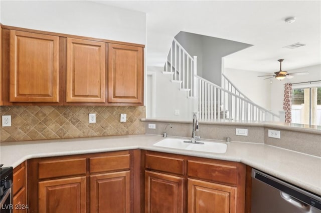 kitchen featuring decorative backsplash, stove, ceiling fan, sink, and dishwasher