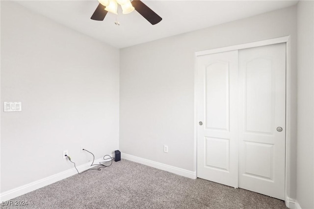 interior space with ceiling fan, a closet, and carpet floors