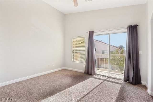 empty room with ceiling fan and carpet floors