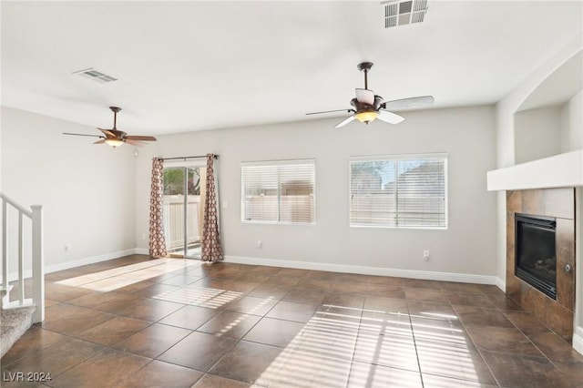 unfurnished living room featuring a fireplace and ceiling fan