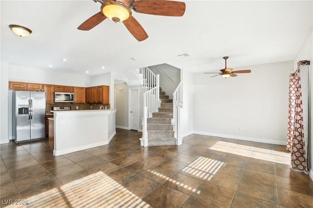 kitchen featuring tasteful backsplash, ceiling fan, and appliances with stainless steel finishes