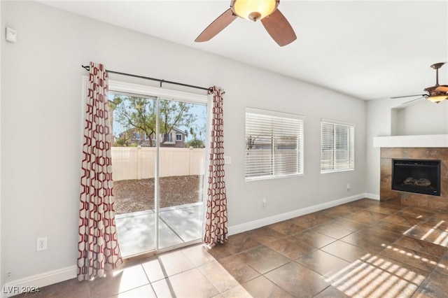 unfurnished living room featuring tile patterned flooring and a tiled fireplace