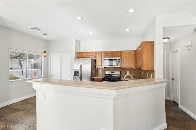 kitchen featuring kitchen peninsula, tasteful backsplash, stainless steel appliances, sink, and hanging light fixtures