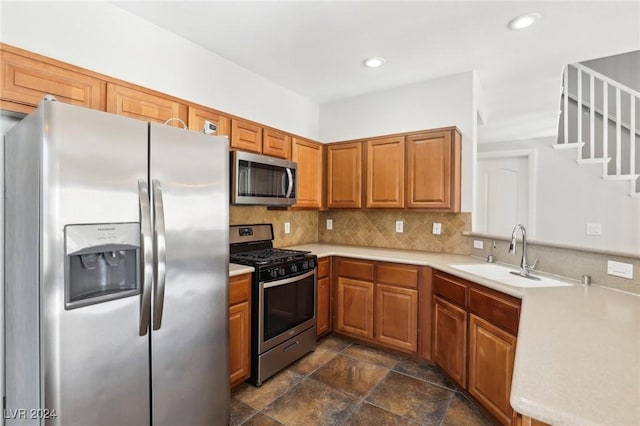 kitchen with decorative backsplash, sink, and stainless steel appliances