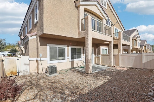 back of house with a patio area, a balcony, and central AC