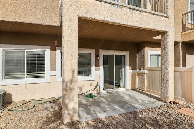 view of exterior entry with a patio