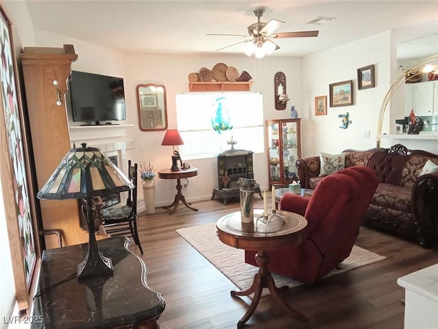 living room featuring wood-type flooring and ceiling fan