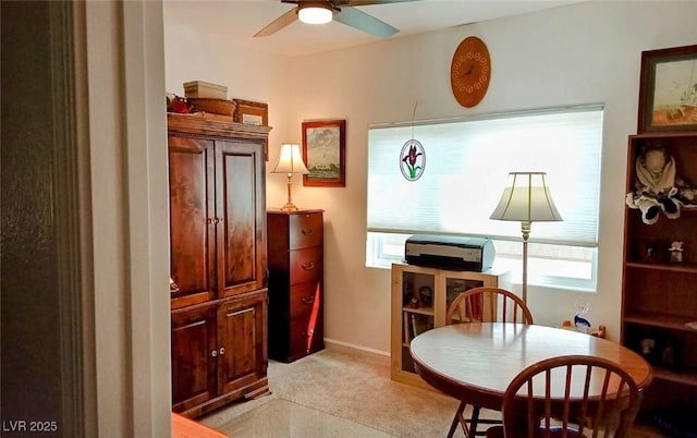 office space featuring ceiling fan and light carpet