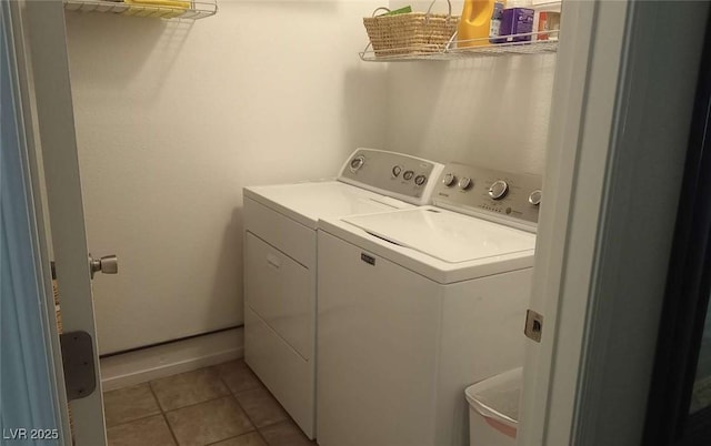 clothes washing area featuring washer and dryer and light tile patterned floors