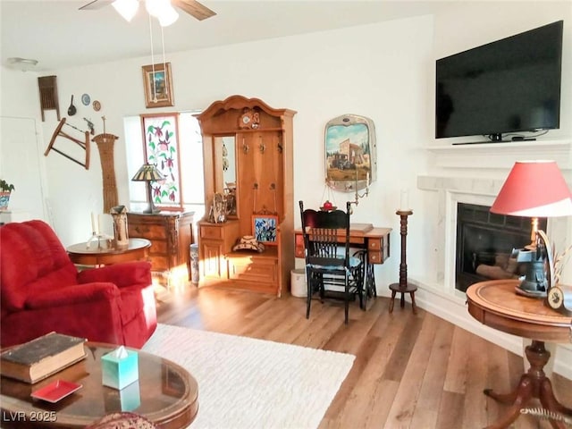 living room with light wood-type flooring and ceiling fan