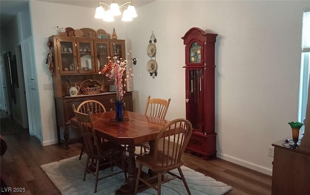 dining area featuring an inviting chandelier and dark hardwood / wood-style flooring