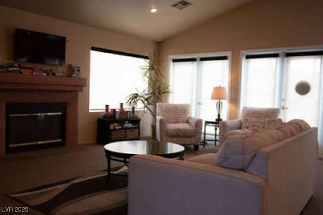 living room featuring plenty of natural light and lofted ceiling