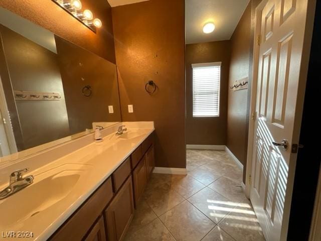 bathroom with tile patterned floors and vanity