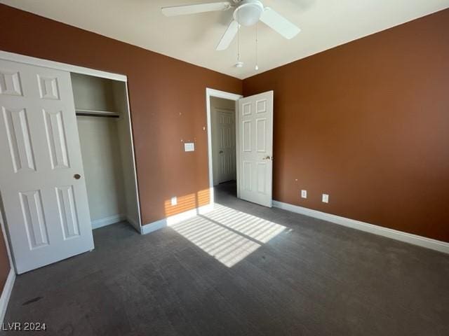 unfurnished bedroom with ceiling fan, a closet, and dark carpet