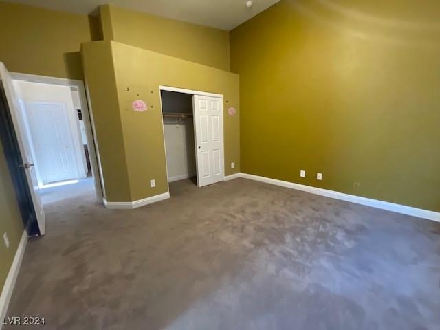 unfurnished bedroom featuring carpet flooring and a closet