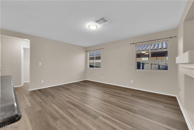 unfurnished living room featuring wood-type flooring