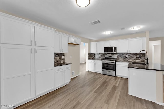 kitchen with white cabinetry, sink, and appliances with stainless steel finishes